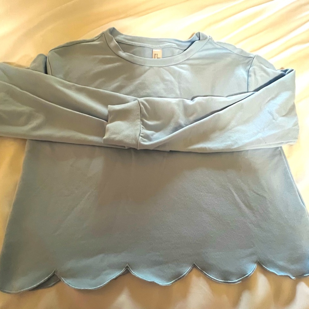 Baby blue long sleeve scalloped bottom shirt, slightly cropped
